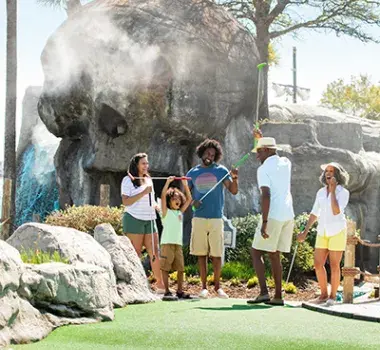 Family playing Mini golf