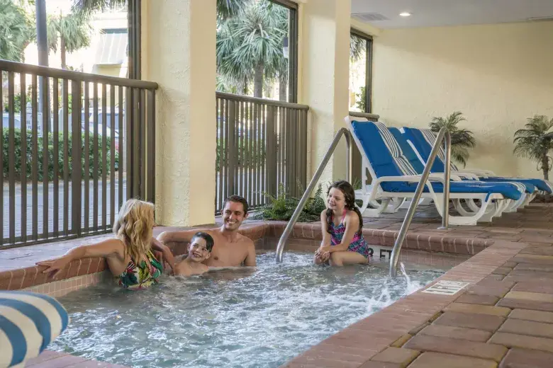Family sitting in hot tub. Photo 18