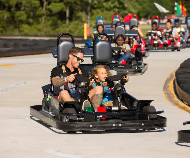 A father and sone race in a Go-Cart at Broadway Grand Prix